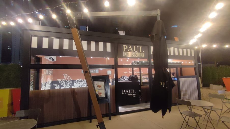 An illuminated exhibition identity delivered across structure, counter and signage.