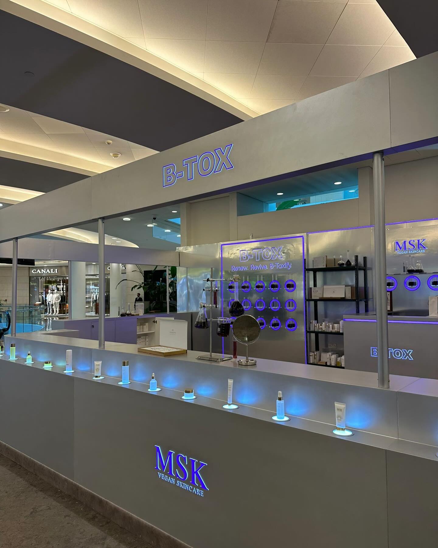 An illuminated exhibition identity delivered across structure, counter and signage.